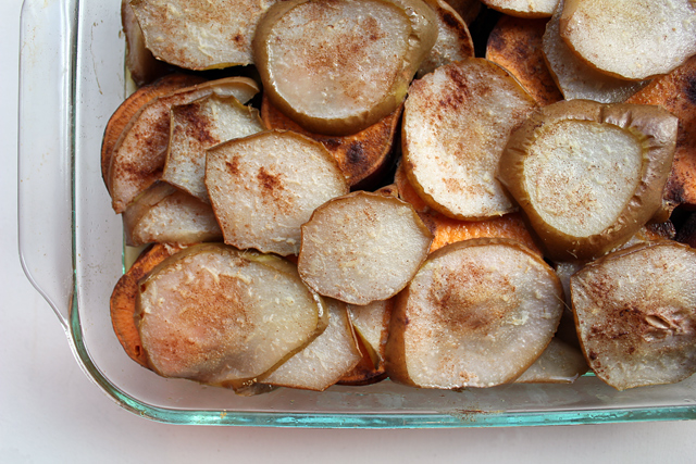 sliced pears and yams layered in a dish