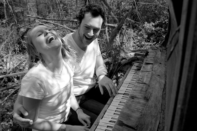engagement photo laughing at piano
