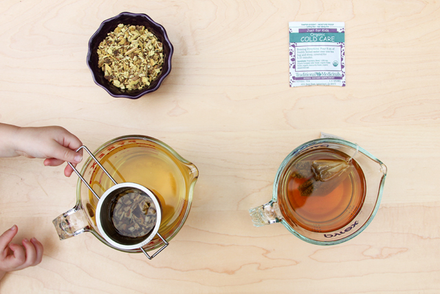 kid playing with herbal treatment tea