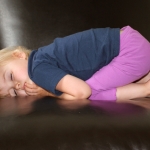 child sleeping in chair