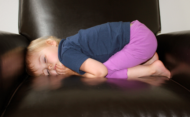 child sleeping in chair