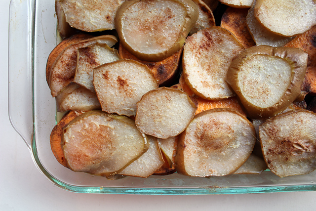 sliced pears and yams layered in a dish