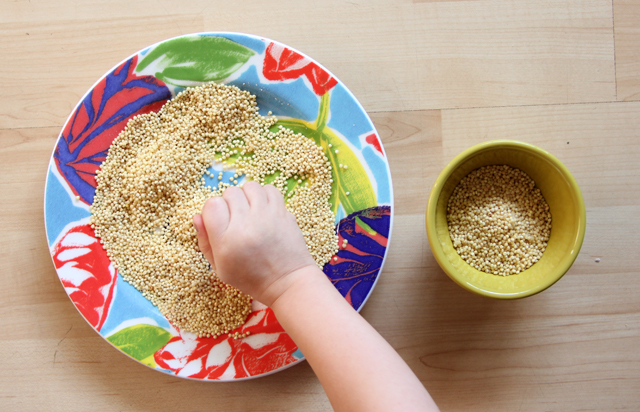 kid playing with millet