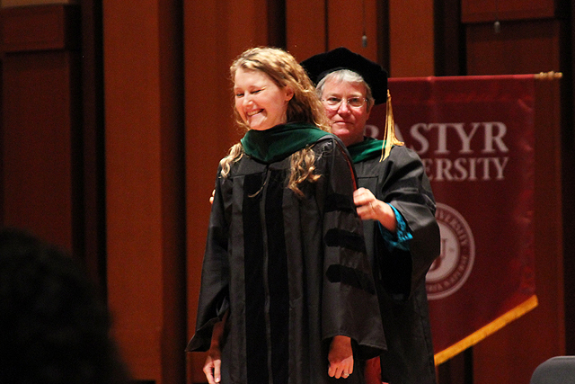 Dr. Archer Atkins getting her doctoral hood